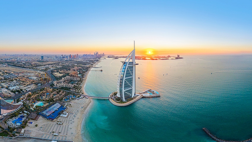 Dubai's iconic Burj Al Arab and coastline at sunset \| MSC Cruises