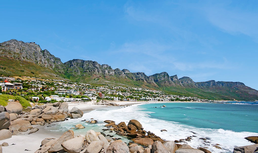 Scenic coastal view of Camps Bay with turquoise waters and the Twelve Apostles mountain range \| MSC Cruises