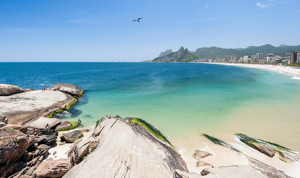 Scenic view of Ipanema Beach with turquoise waters and distant mountains in Rio de Janeiro \| MSC Cruises