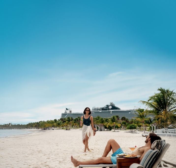 A couple having drinks by the beach on their MSC Cruises Ship