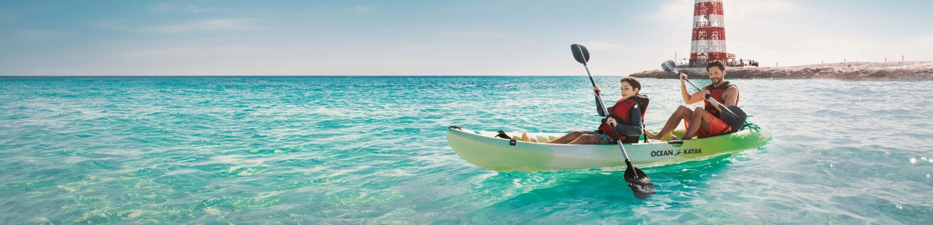 Father and son happily kayaking at Ocean Cay MSC Marine Reserve | MSC Cruises