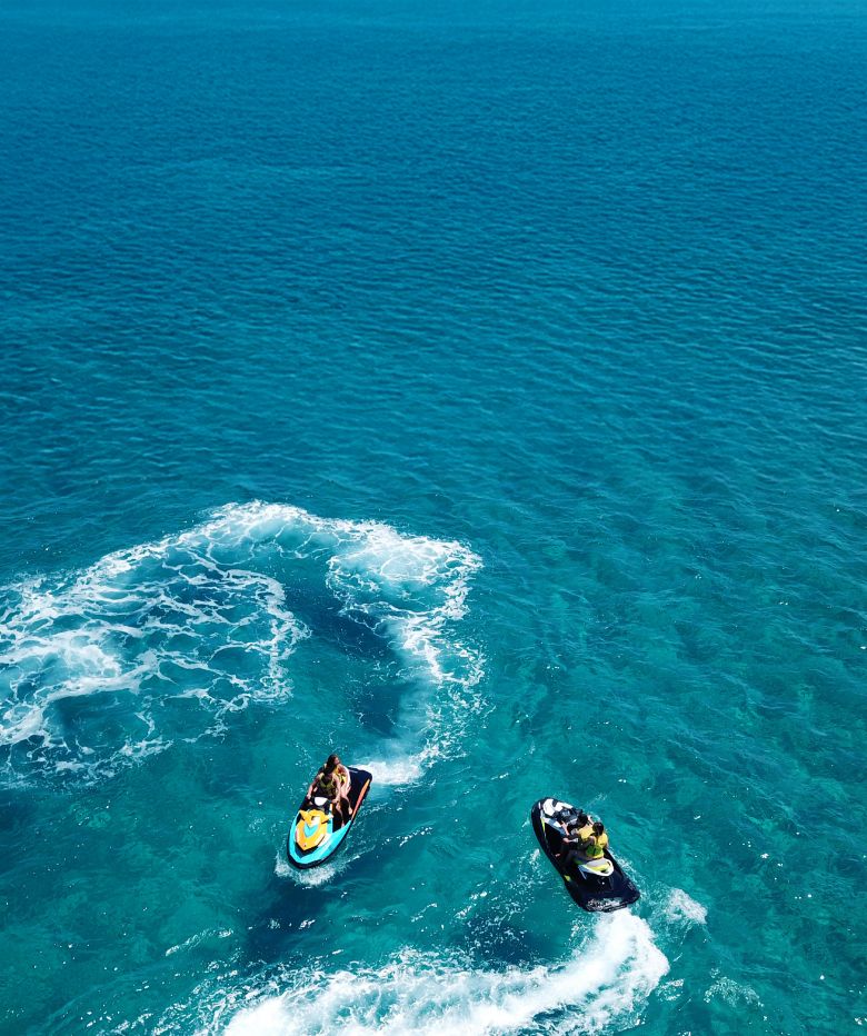 Two guests enjoying a jet sky ride at Ocean Cay Marine Reserve, the private island of MSC Cruises.