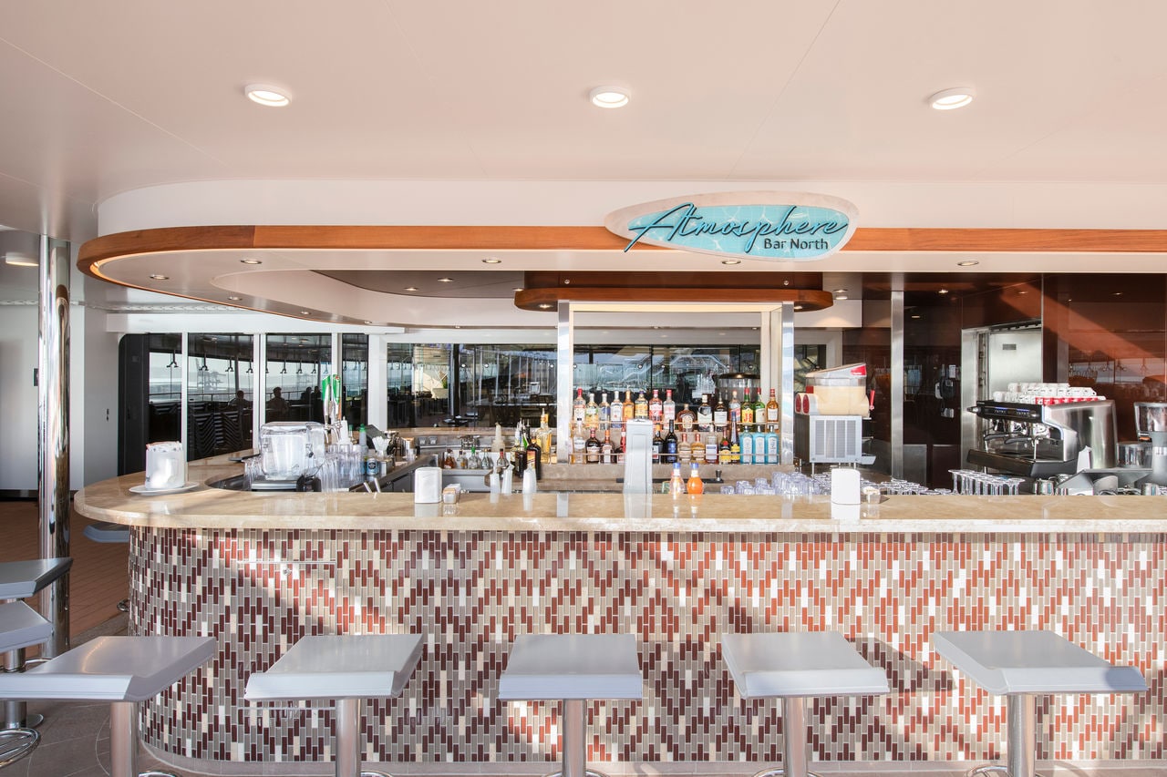 Atmosphere Bar North on MSC Grandiosa features comfortable seating and a vibrant bar area | MSC Cruises
