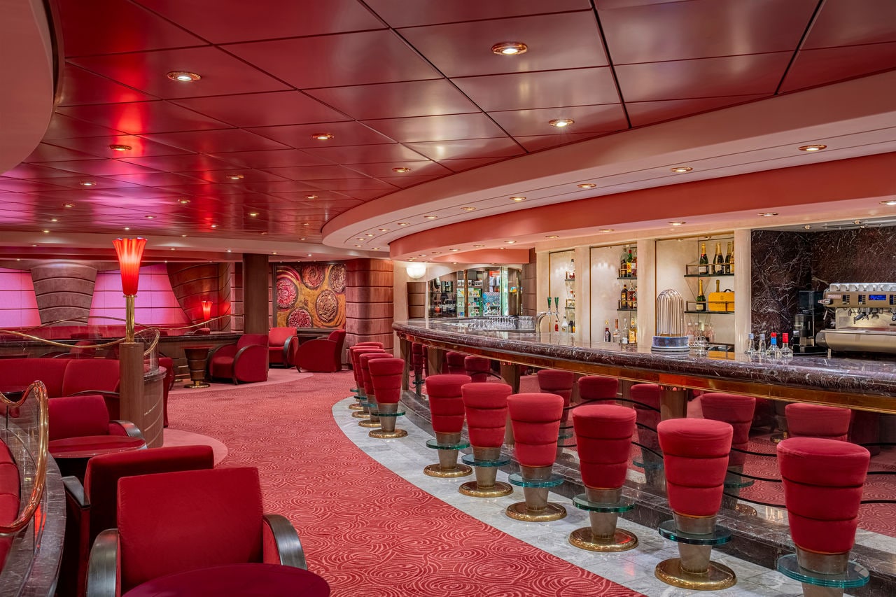 Bar and inviting seating area in the warm atmosphere of MSC Poesia | MSC Cruises