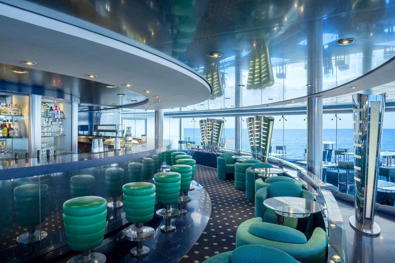 Modern bar with comfortable seating and expansive windows overlooking the sea | MSC Cruises