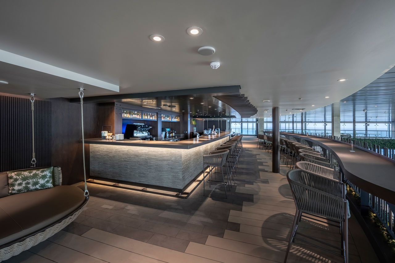 Botanic Garden Bar on MSC World Europa welcomes guests with stylish seating and a relaxing lounge atmosphere | MSC Cruises