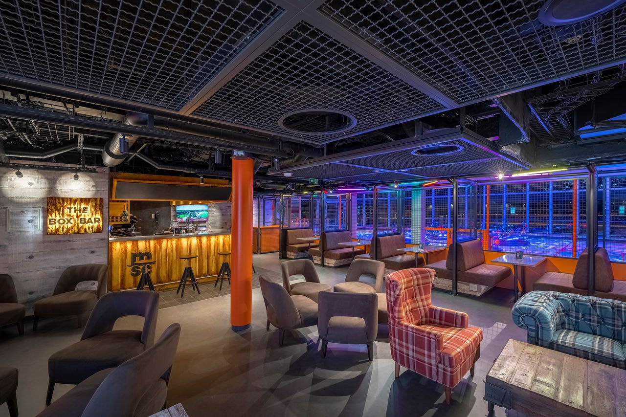 The Box Bar on MSC World Europa features modern seating and vibrant lounge ambiance | MSC Cruises