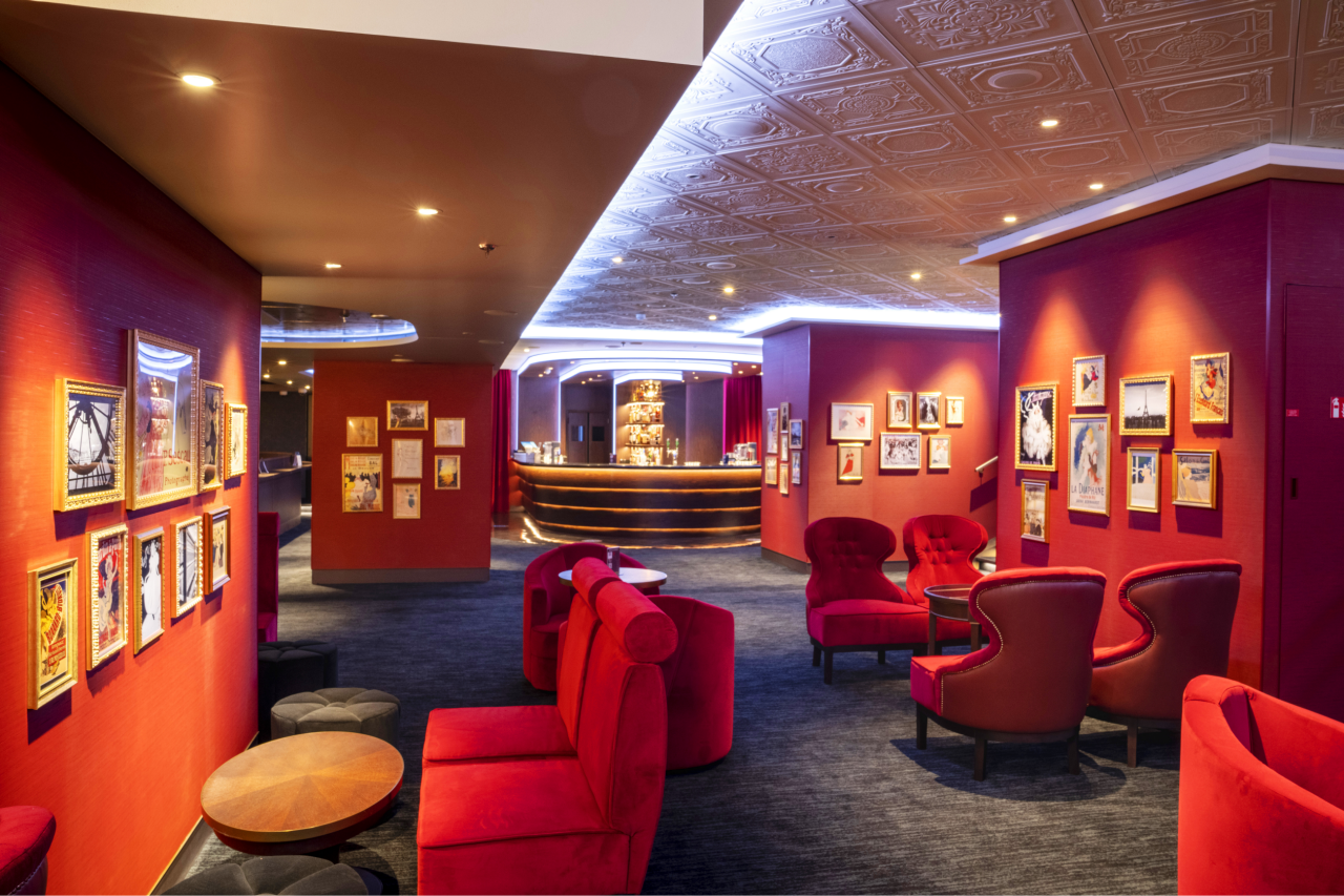 A stylish lounge with red chairs and a welcoming atmosphere for relaxation onboard | MSC Cruises