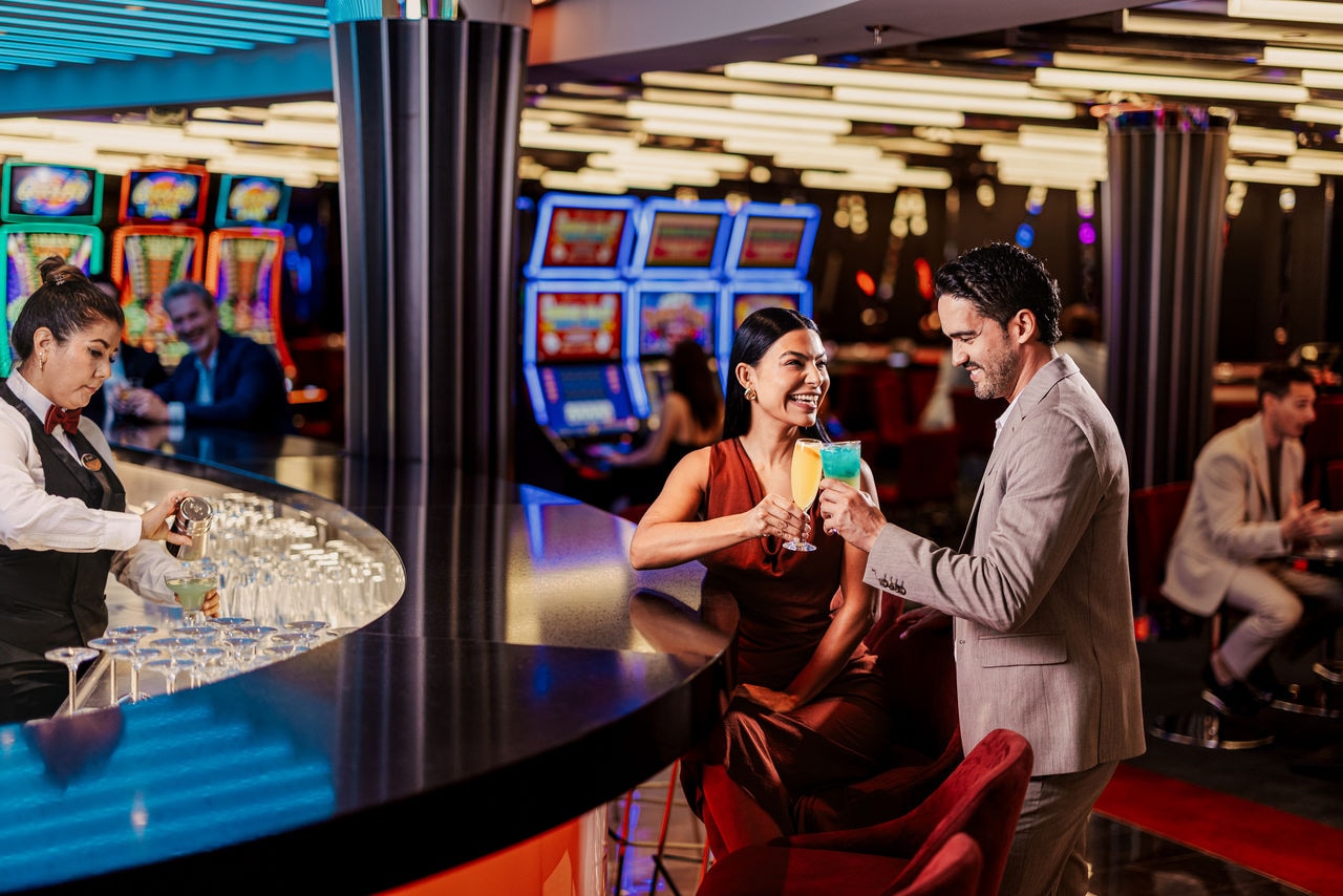 Guests enjoy drinks at the casino bar surrounded by a lively ambiance | MSC Cruises