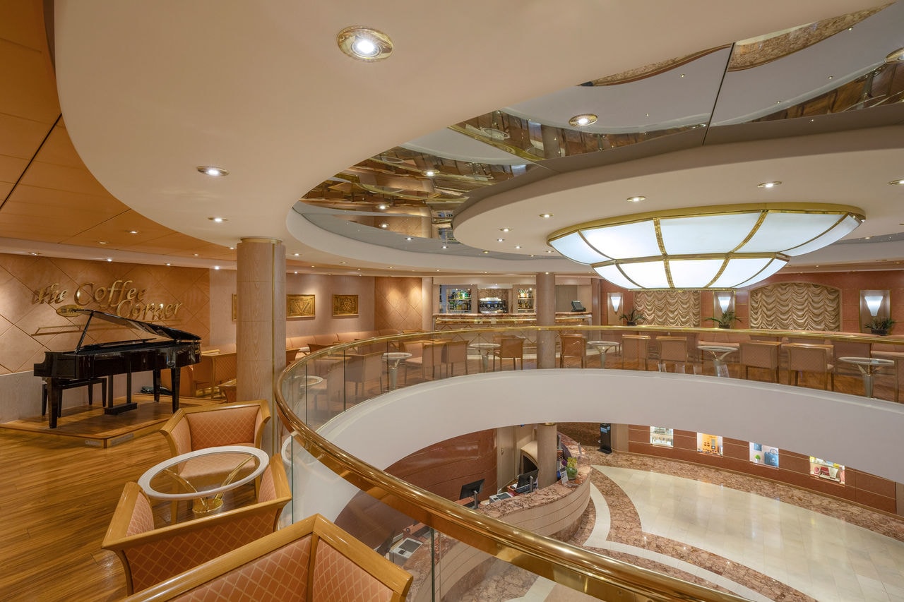 Spacious lounge with piano and bar, featuring comfortable seating areas on MSC Lirica | MSC Cruises