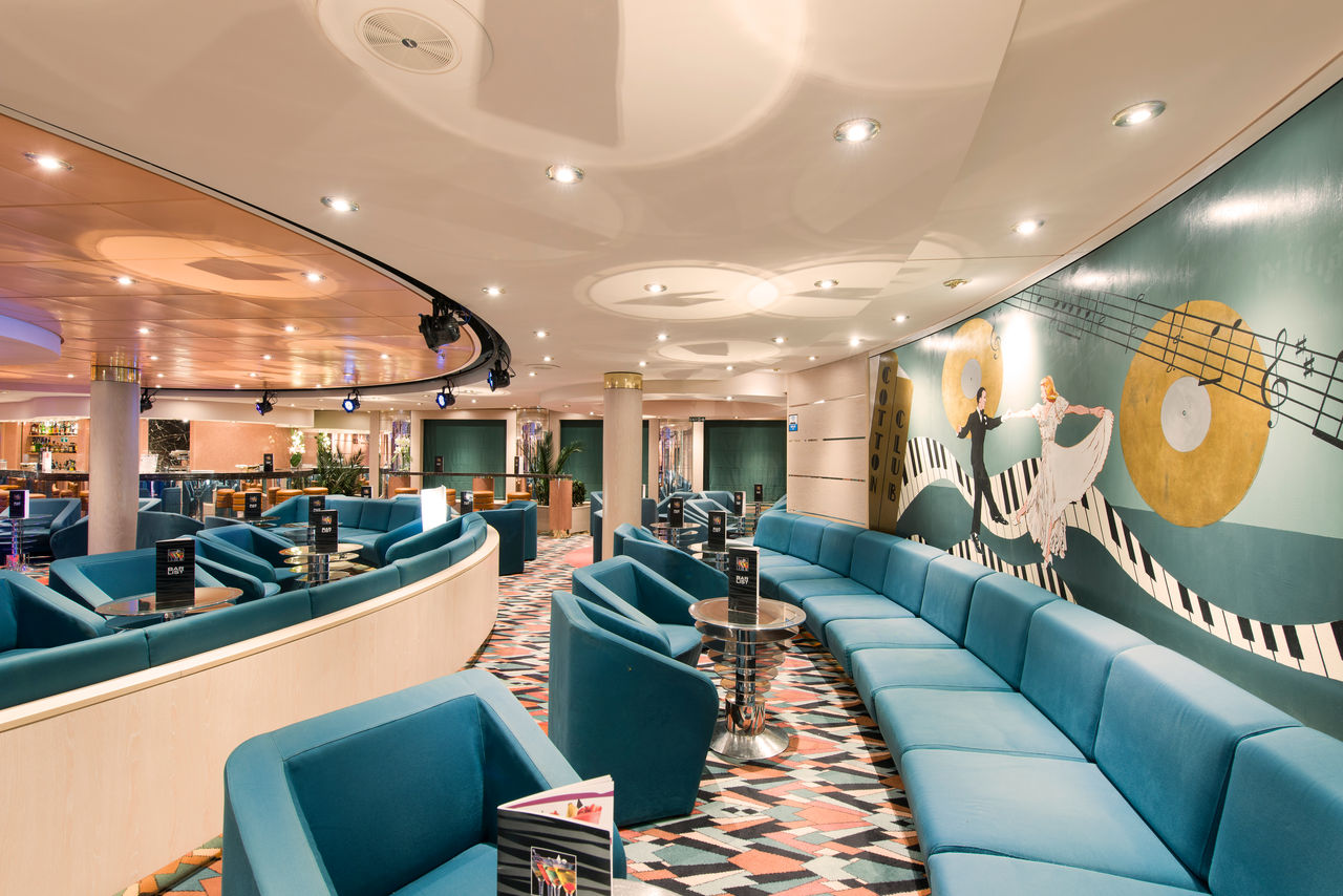Contemporary lounge area with sofas and tables aboard MSC Opera | MSC Cruises