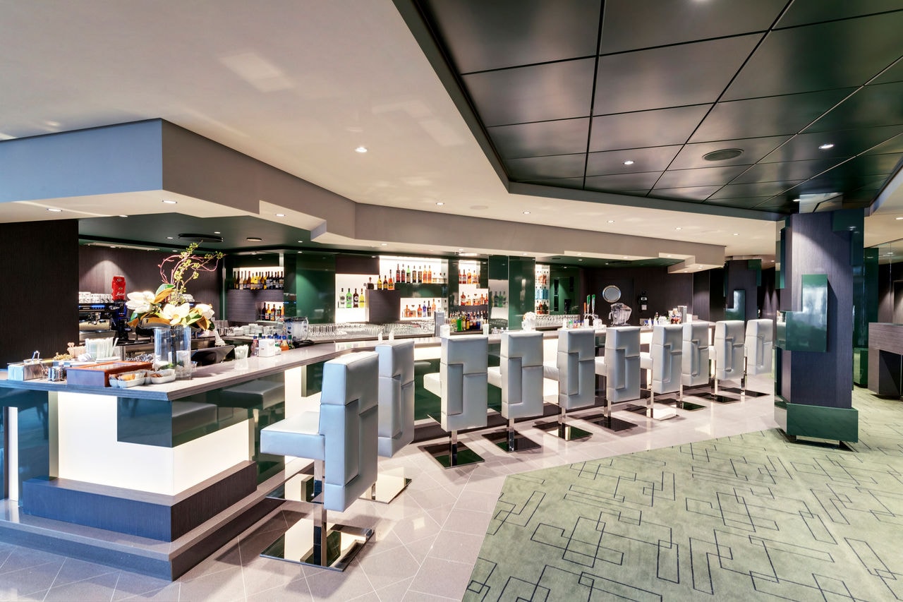 A contemporary bar with stylish seating and a welcoming ambiance on MSC Grandiosa | MSC Cruises