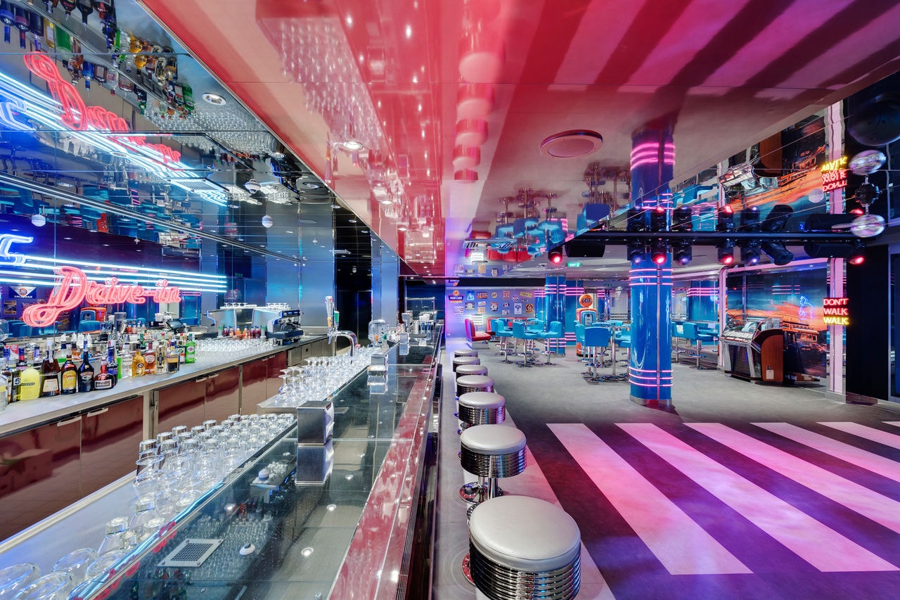 Vibrant bar and club with modern lighting and colorful interior accents | MSC Cruises