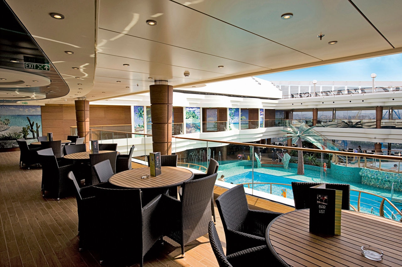 Inviting seating by the pool on MSC Fantasia offers guests a relaxing bar experience | MSC Cruises