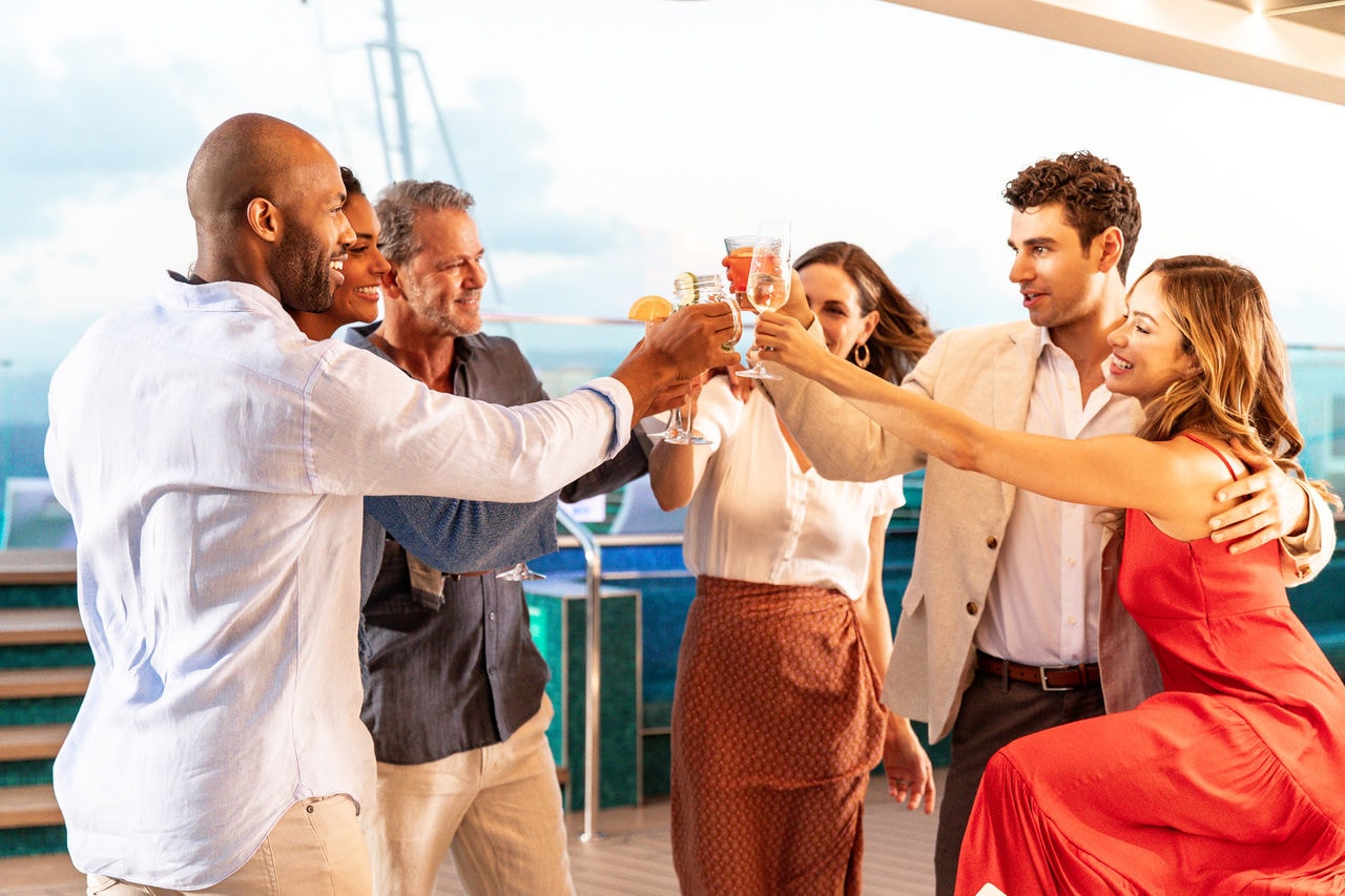 A group of friends share a joyful toast together on a cruise ship deck | MSC Cruises