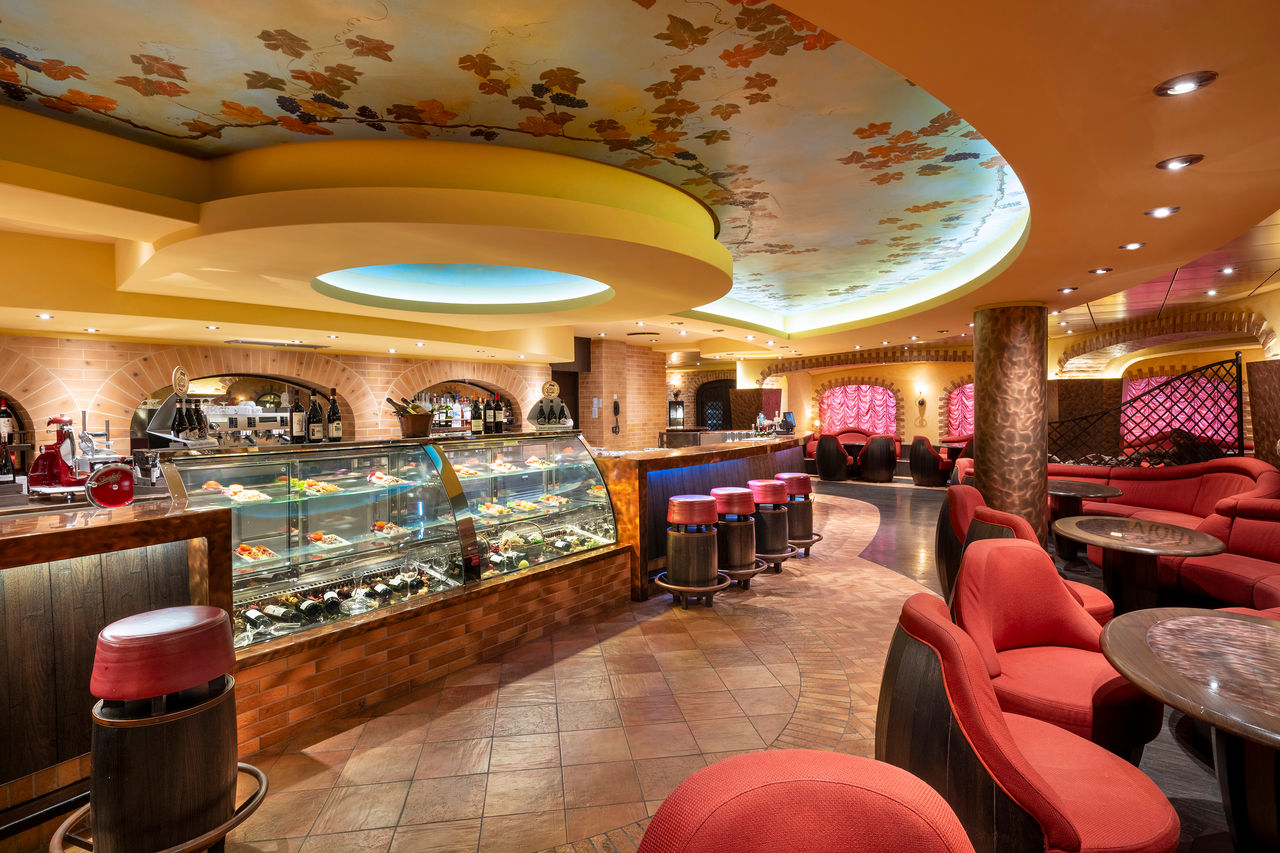 Bar and lounge area with comfortable seating and a modern bar counter on MSC Fantasia | MSC Cruises
