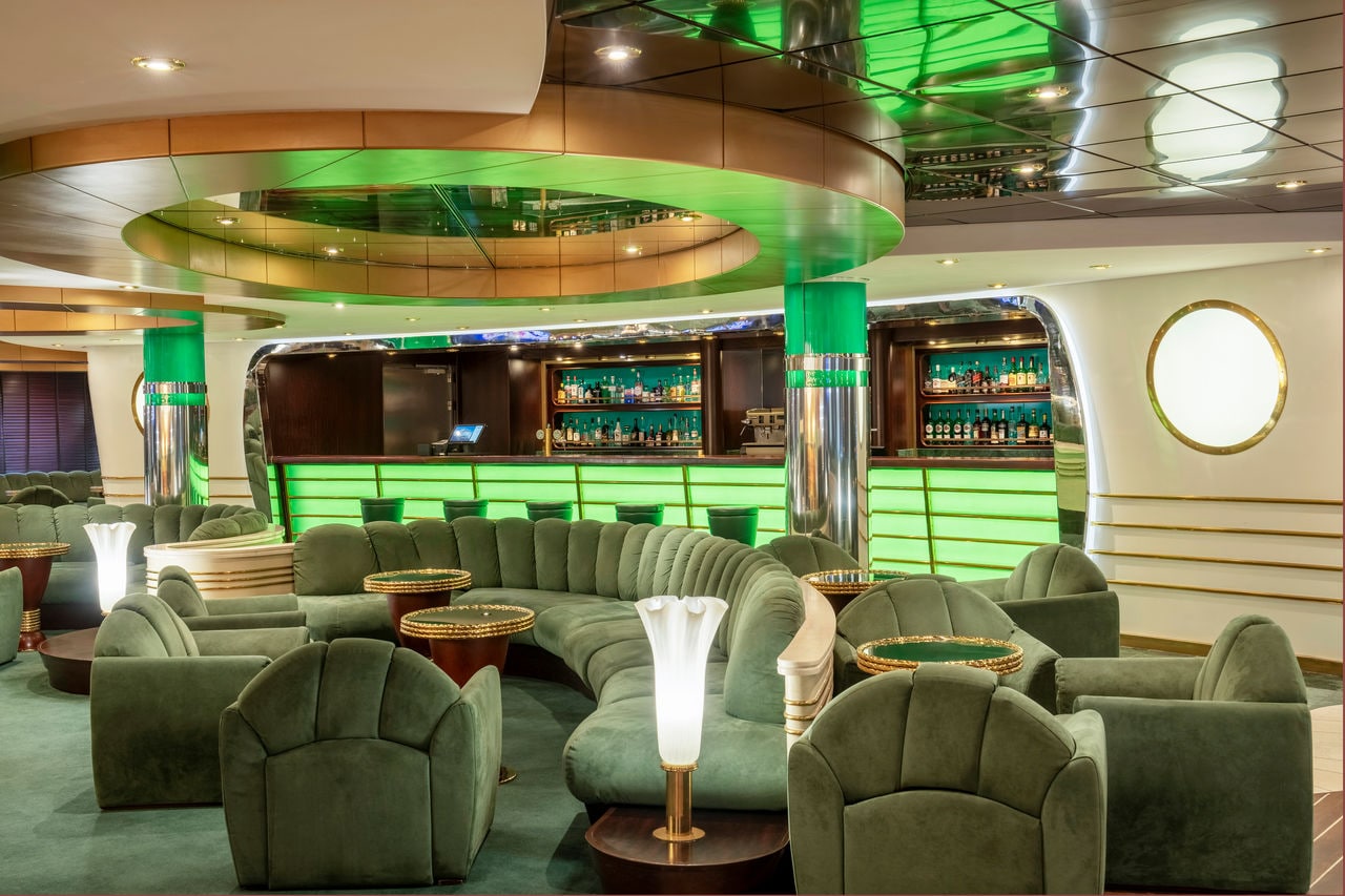 Seating area with armchairs and tables in La Prua Piano Bar aboard MSC Splendida | MSC Cruises