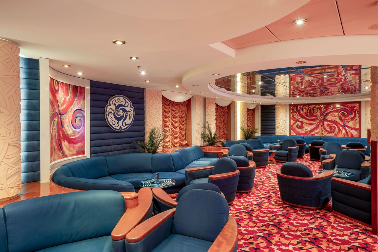 Inviting blue sofas and tables in the L'Incontro Bar lounge area on MSC Orchestra | MSC Cruises