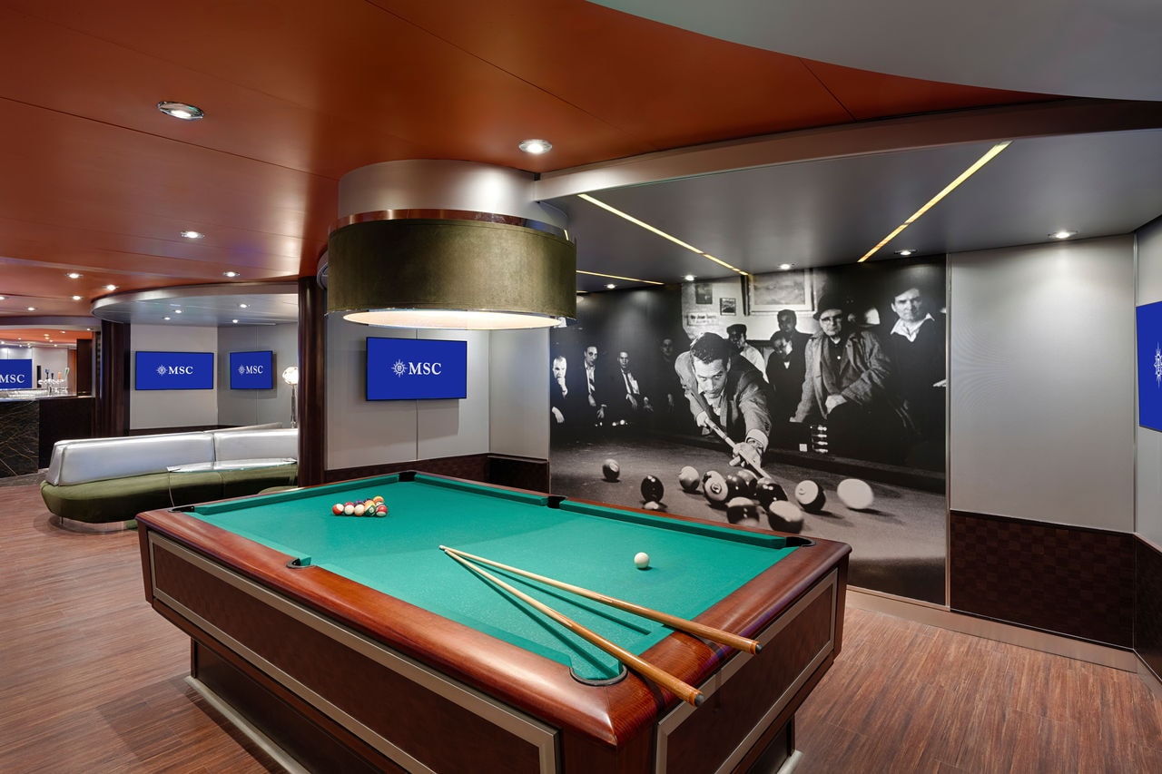Pool table and inviting seating area in a contemporary sports bar on a cruise ship | MSC Cruises