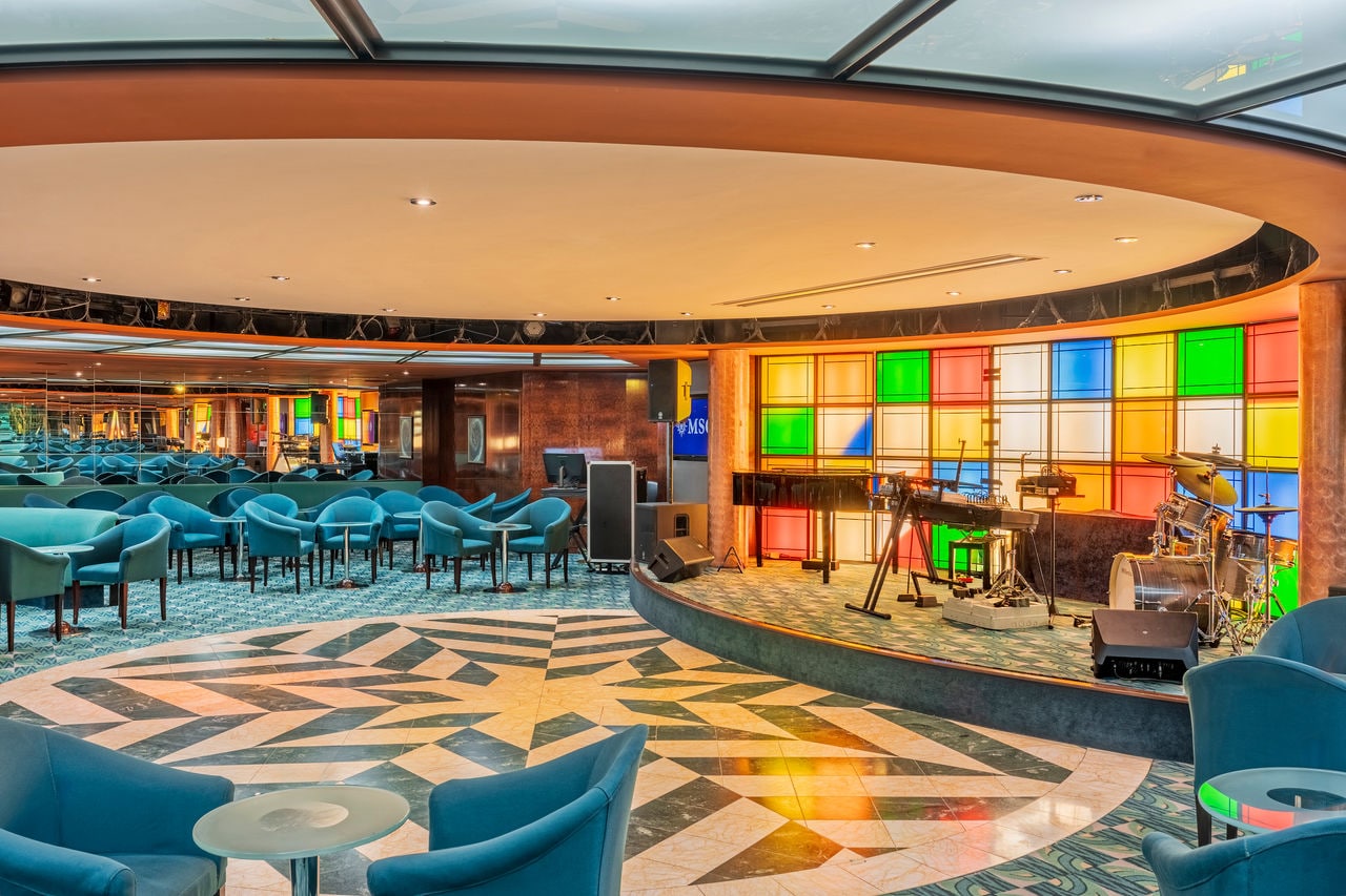 Manhattan Bar on MSC Sinfonia features a stage, dance floor and inviting seating area | MSC Cruises