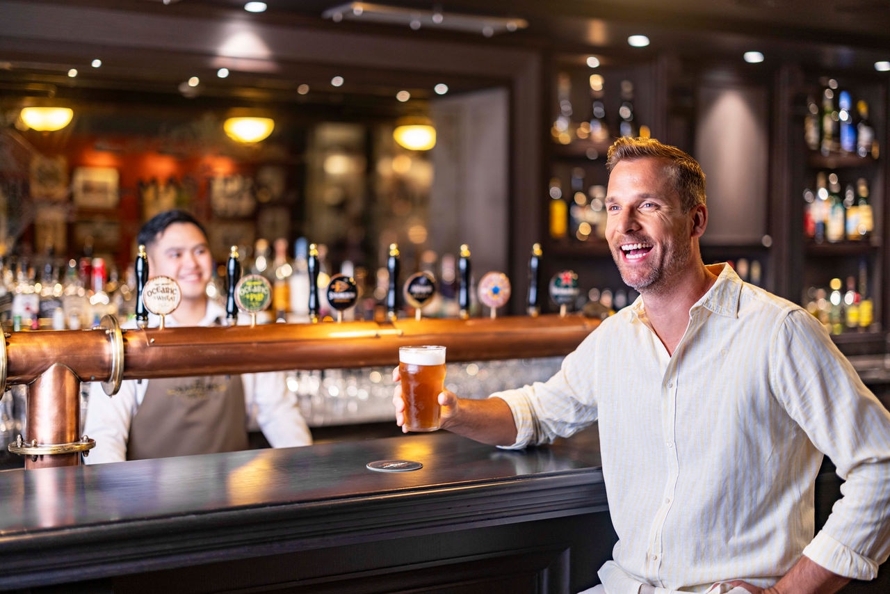 Guest enjoys the welcoming vibe at Masters of the Sea bar on MSC World Europa | MSC Cruises