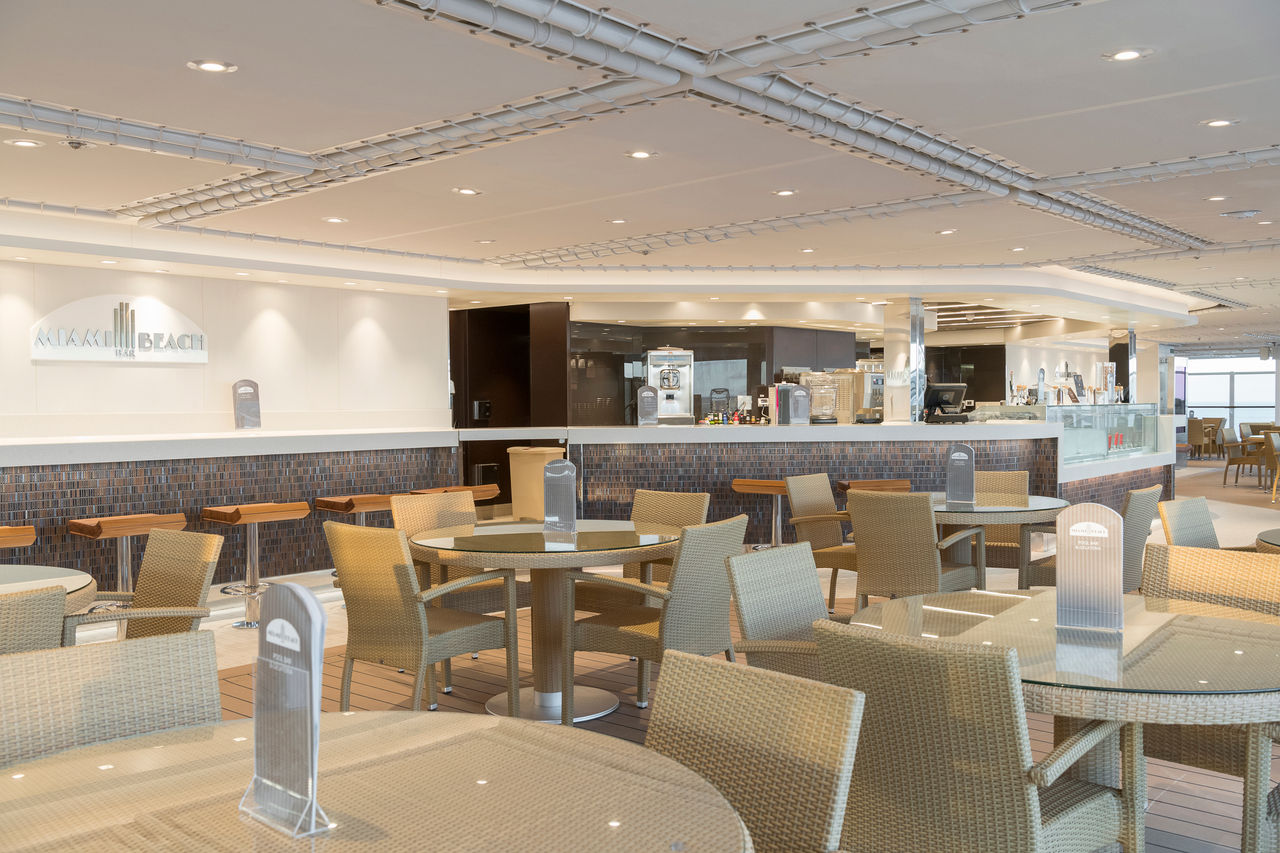 Miami Beach Bar on MSC Seaside featuring inviting seating and a stylish bar counter | MSC Cruises