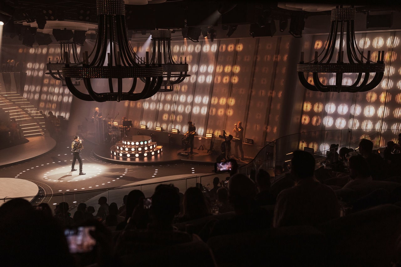 Audience enjoys a vibrant stage performance in a spacious cruise ship theater | MSC Cruises