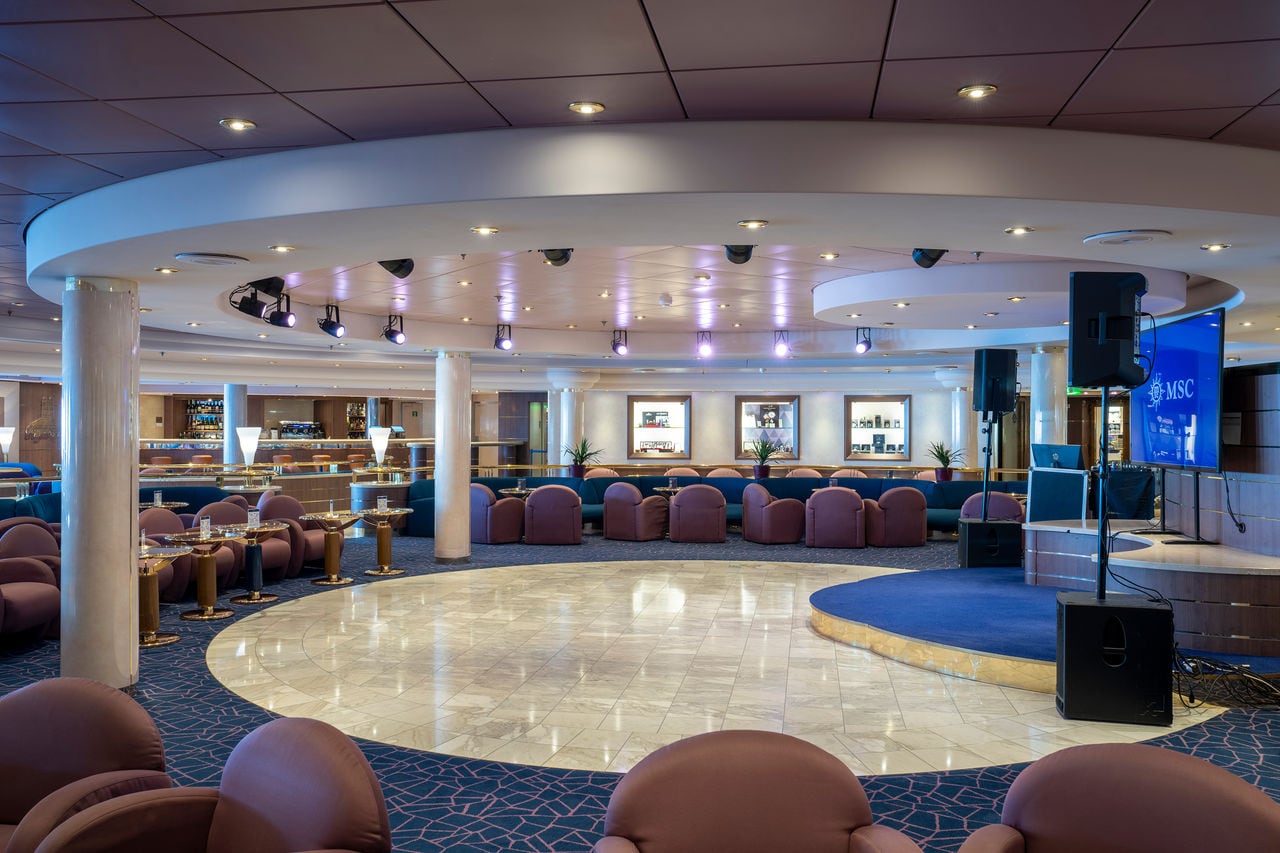 Piazza di Spagna featuring bar counter, dance floor and stage onboard MSC Opera | MSC Cruises