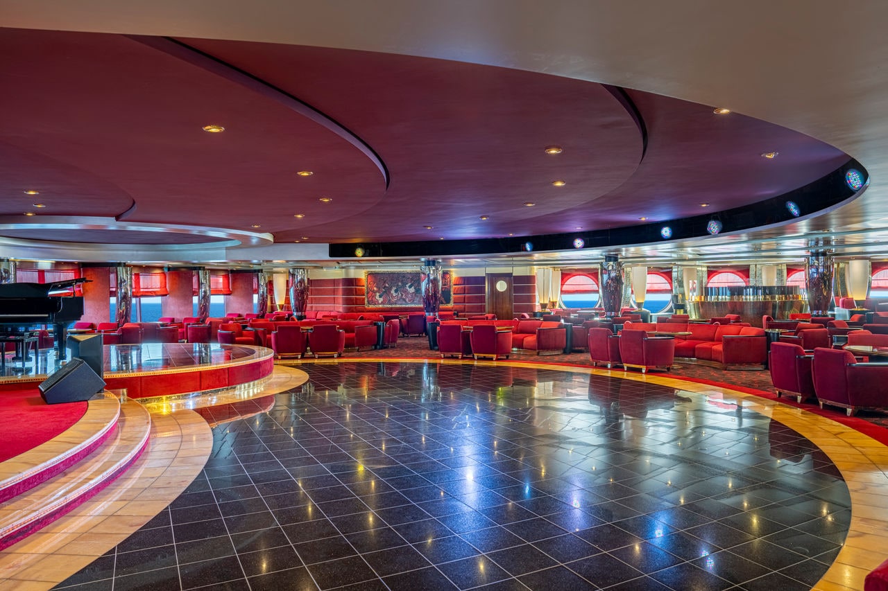 Pigalle Lounge features inviting seating, a stage, and a dance floor for lively gatherings | MSC Cruises
