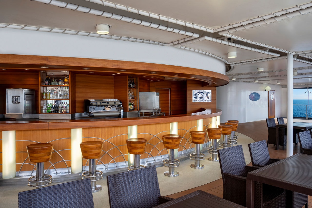 Pirana Bar on a cruise ship featuring seating areas and a scenic sea view | MSC Cruises