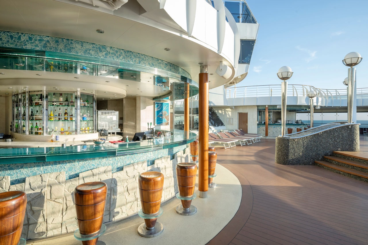 Outdoor bar with stools and sea views on a ship from the fleet | MSC Cruises
