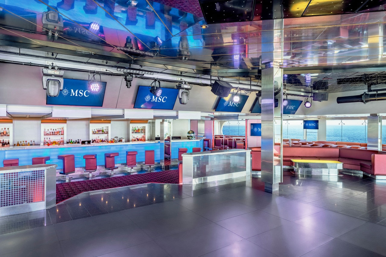 Q32 Disco bar with vibrant seating and spacious dance floor aboard MSC Musica | MSC Cruises