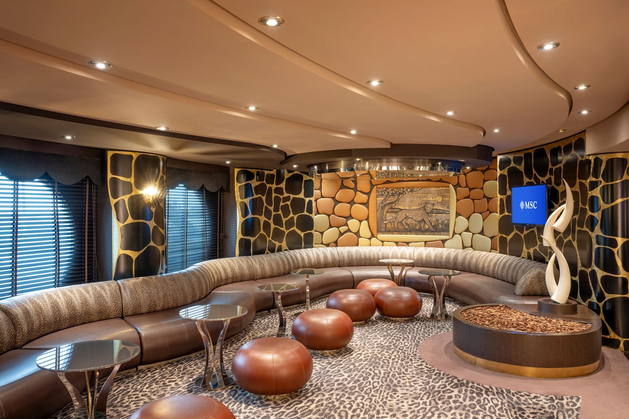 Safari Lounge featuring comfortable seating and a stage for entertainment on the ship | MSC Cruises