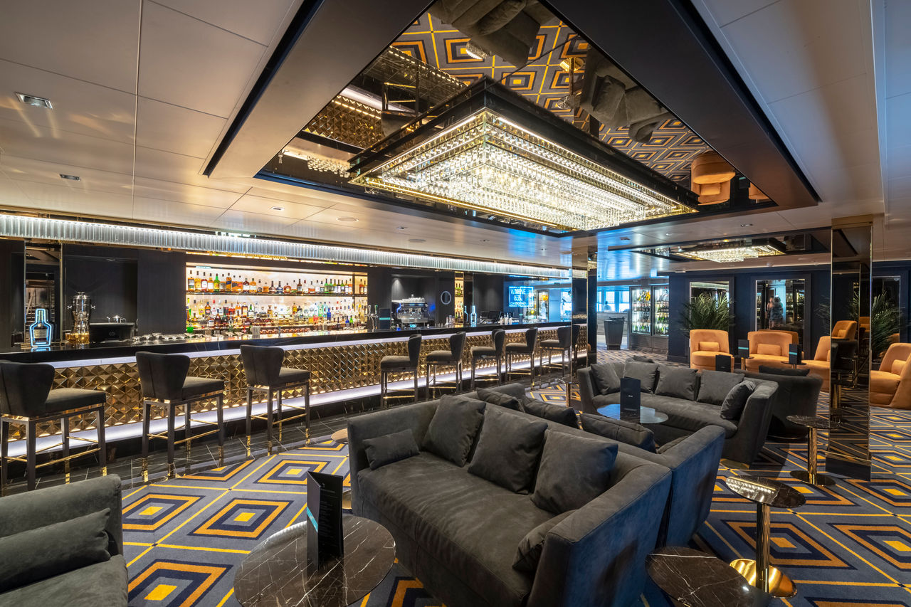 Contemporary bar and lounge area with comfortable seating on board MSC Seaview | MSC Cruises