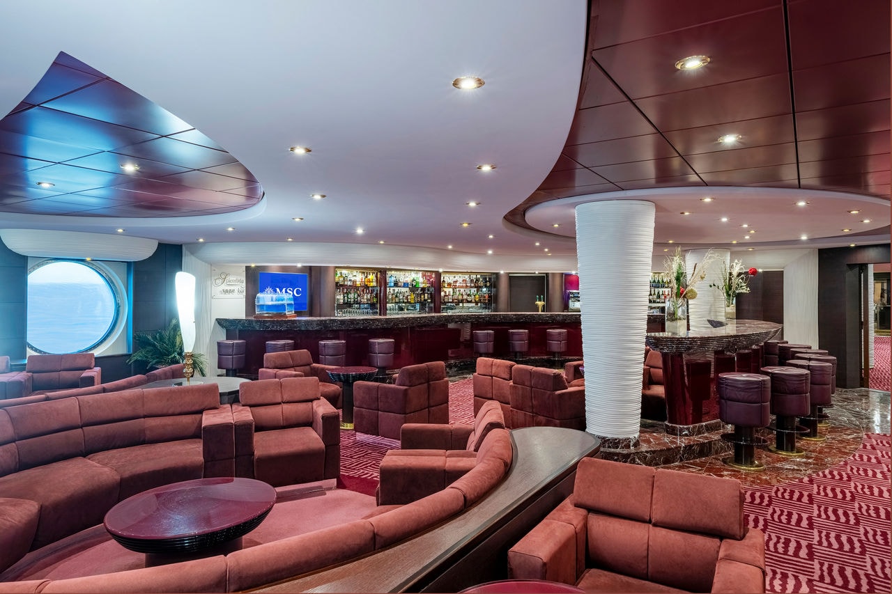 Spacious bar with comfortable seating and portholes aboard MSC Splendida | MSC Cruises