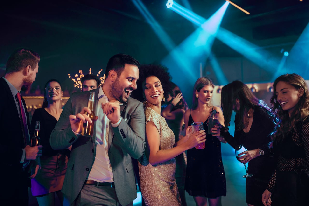 Guests enjoying a lively night at The Amber Bar with drinks and dancing on MSC Orchestra | MSC Cruises