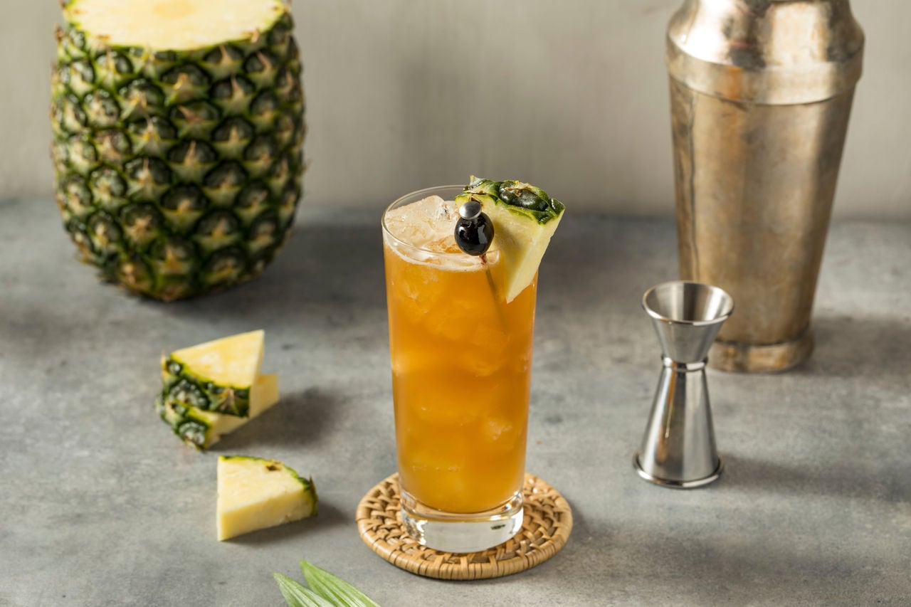 A refreshing Bahama Mama cocktail garnished with pineapple and served in a glass, perfect for Caribbean excursions | MSC Cruises
