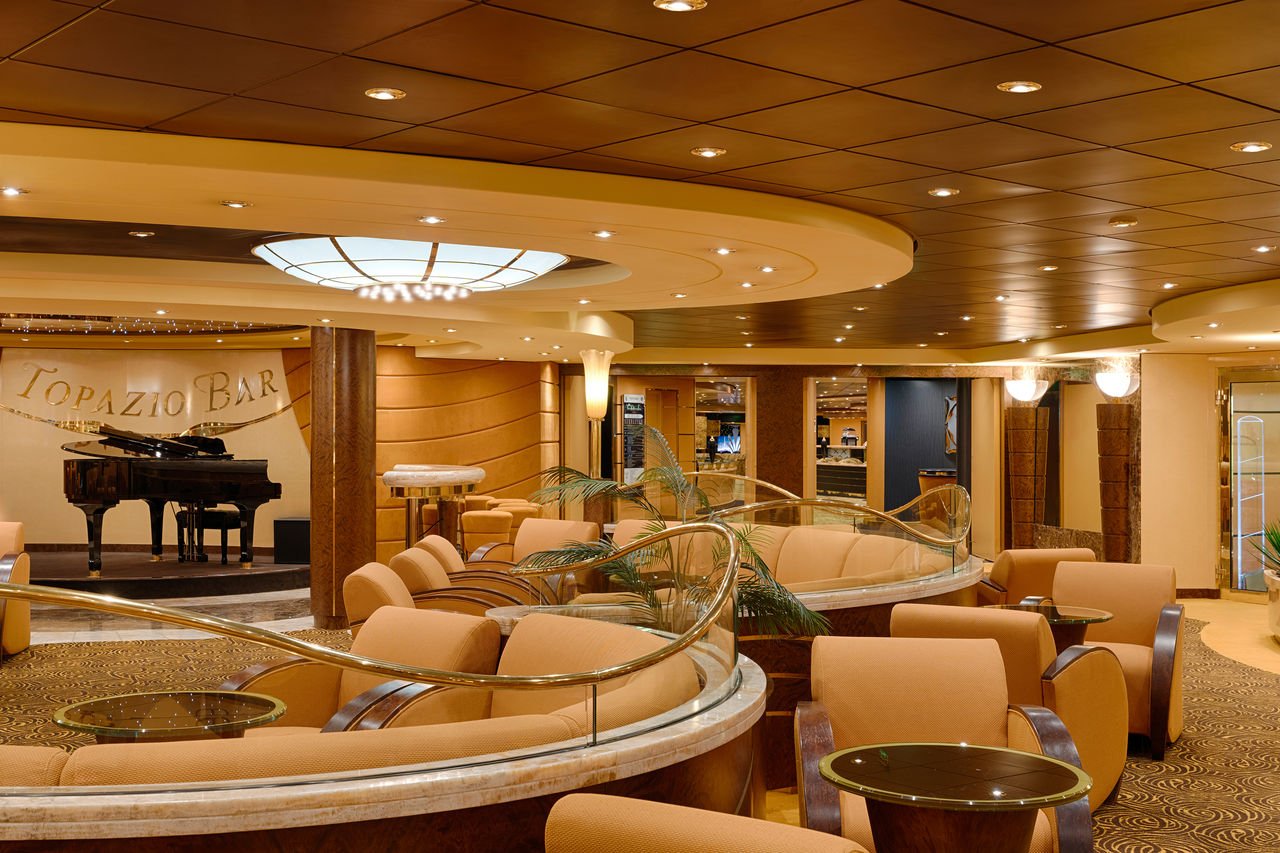 Topazio Bar features comfortable seating, a piano and a welcoming atmosphere for guests | MSC Cruises