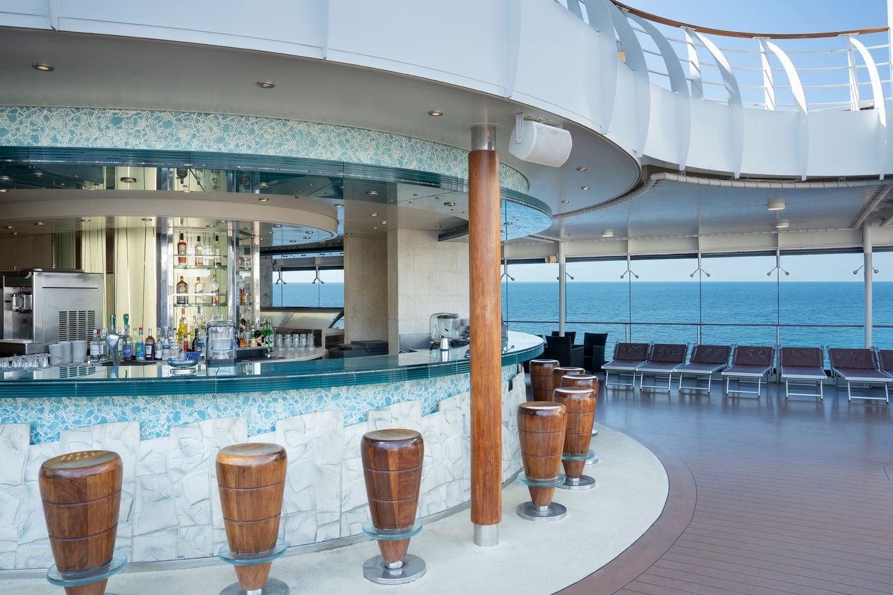 Outdoor bar with comfortable seating and sea views aboard MSC Divina | MSC Cruises