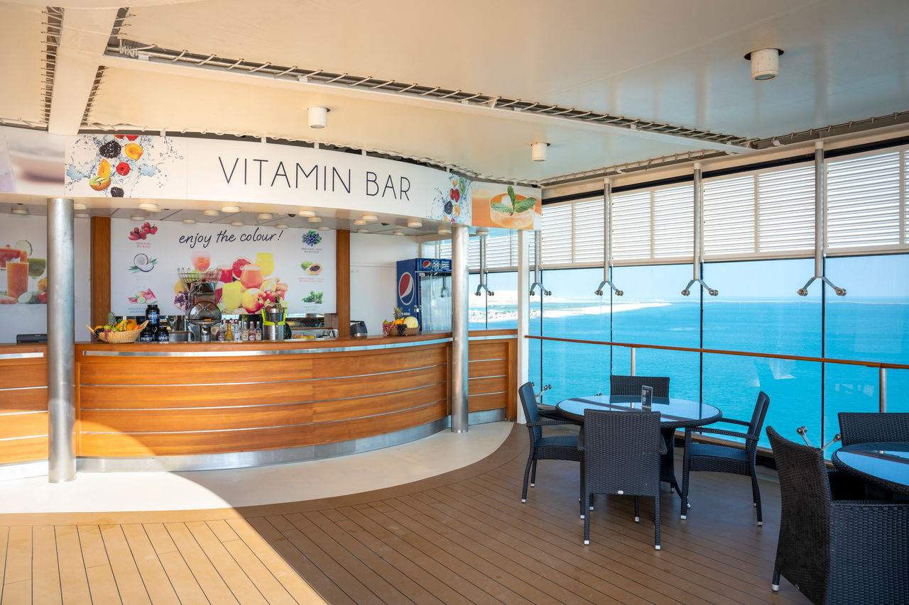 The Vitamin Bar on MSC Opera features a vibrant setting and sea view through expansive glass walls | MSC Cruises