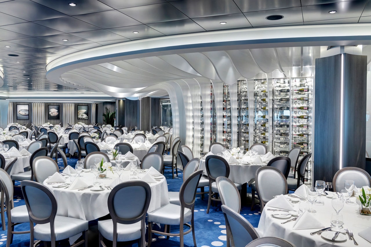Spacious main restaurant with contemporary tables and chairs on MSC Grandiosa | MSC Cruises