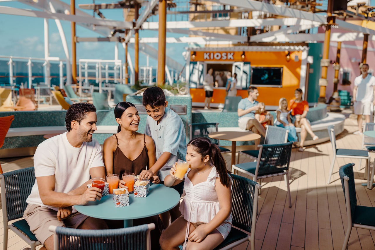 A family enjoys a meal together in a vibrant restaurant aboard a cruise ship | MSC Cruises