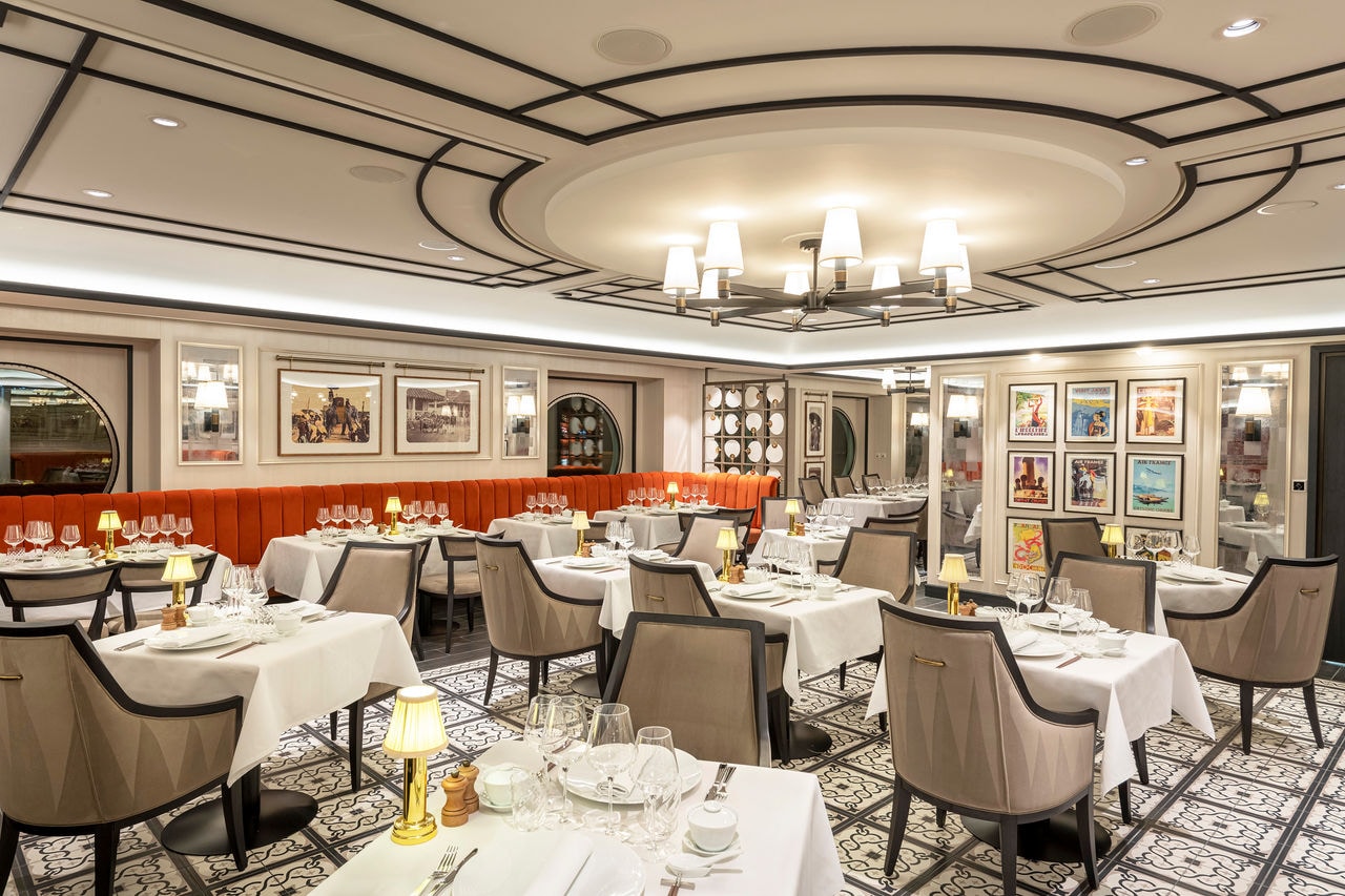 Indochine Restaurant welcomes guests with beautifully arranged tables and comfortable chairs | MSC Cruises