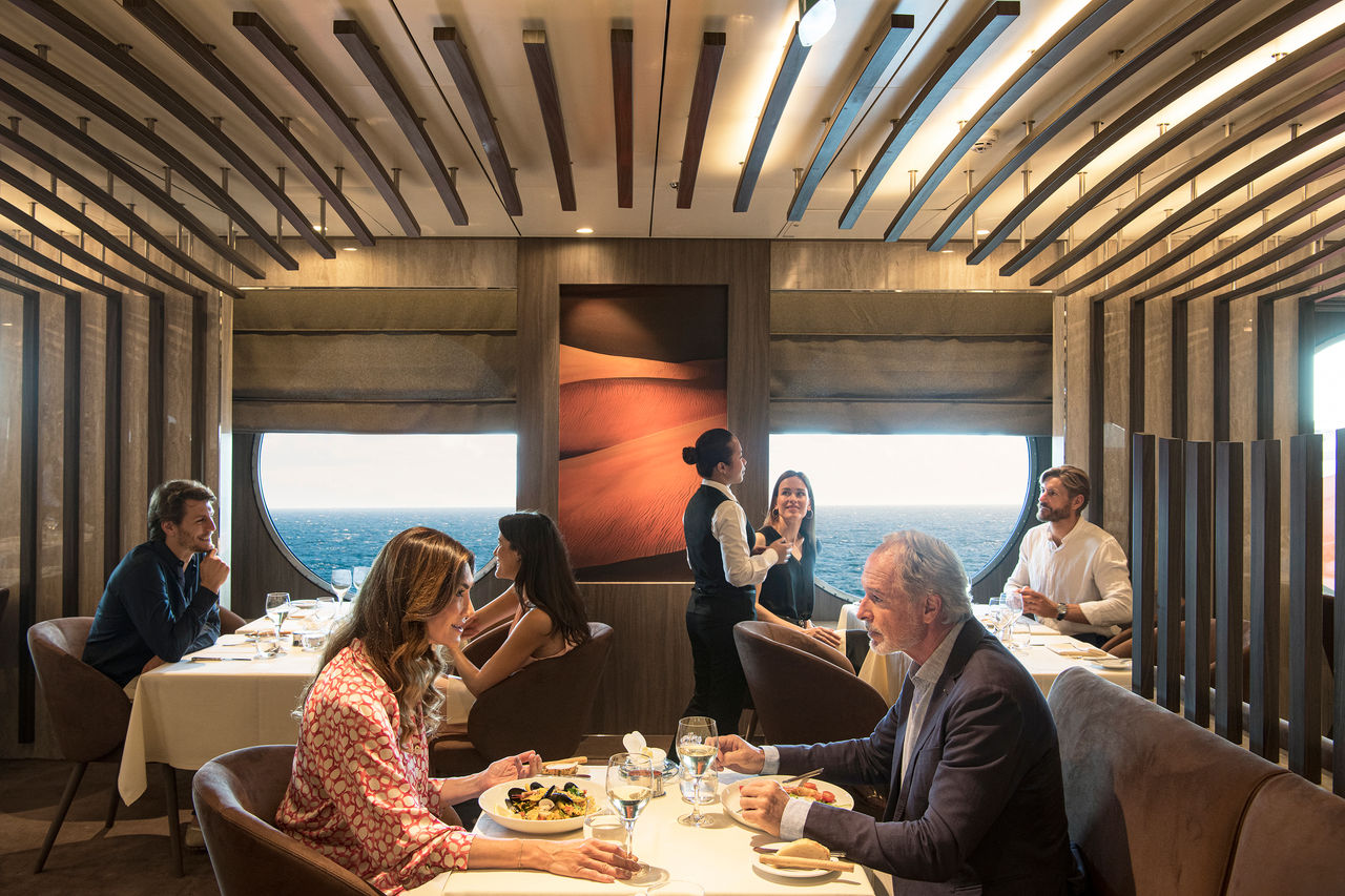 Guests enjoy attentive dining service at a restaurant on MSC World Europa | MSC Cruises