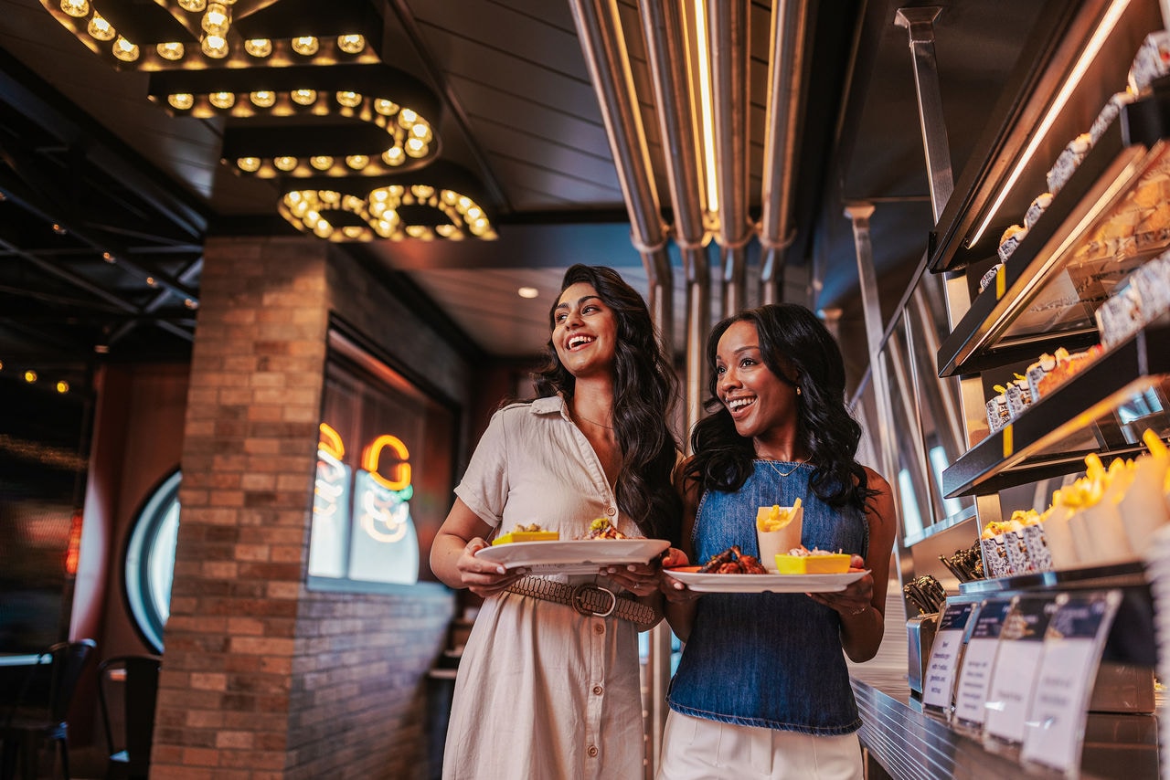 Two women select food in a stylish restaurant aboard a cruise ship | MSC Cruises