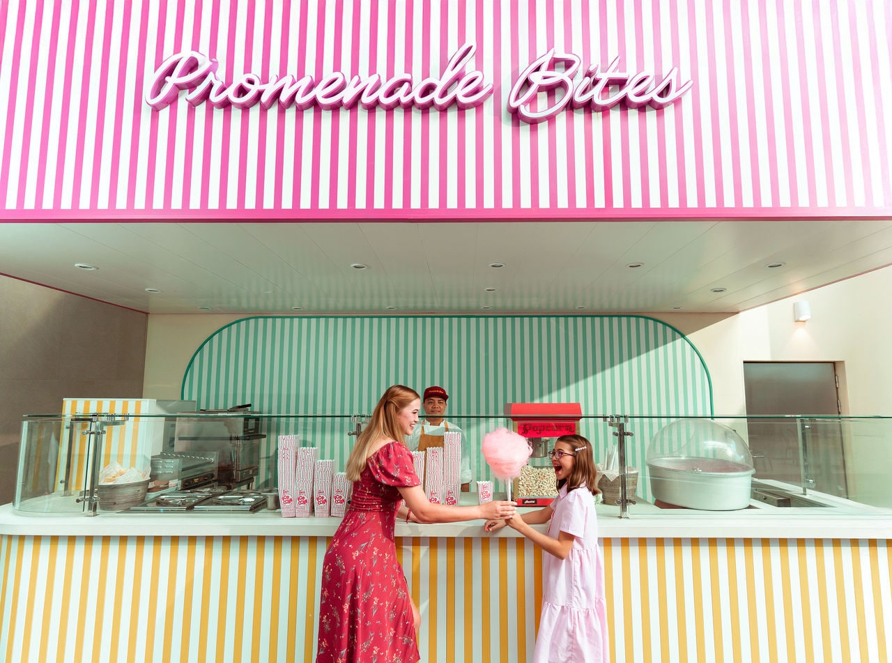 Two children share a treat at a pastel-colored food counter | MSC Cruises