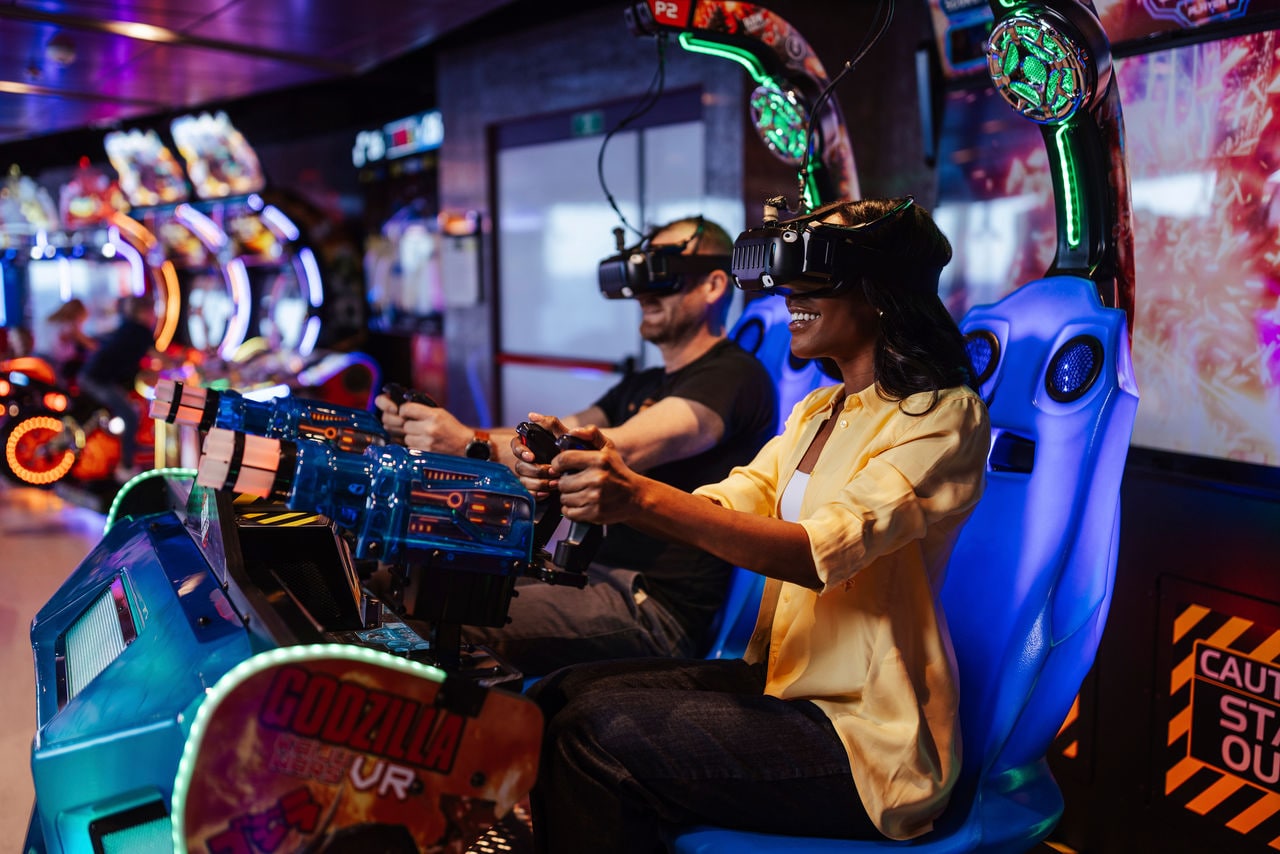 Two people enjoy the VR arcade area together on MSC World America | MSC Cruises