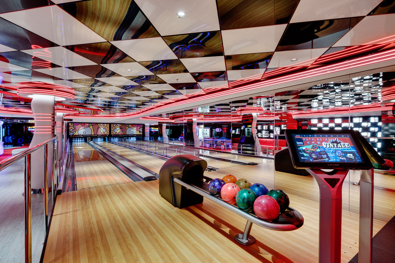 Inviting bowling alley on board with vibrant bowling balls and a stylish entertainment area | MSC Cruises