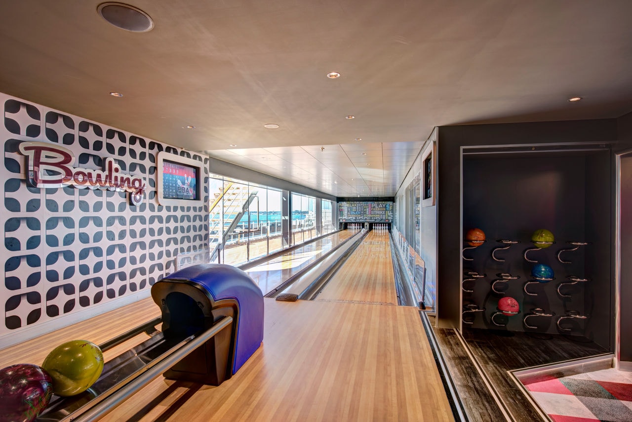 Bowling area on MSC Meraviglia featuring sleek lanes and vibrant bowling balls | MSC Cruises