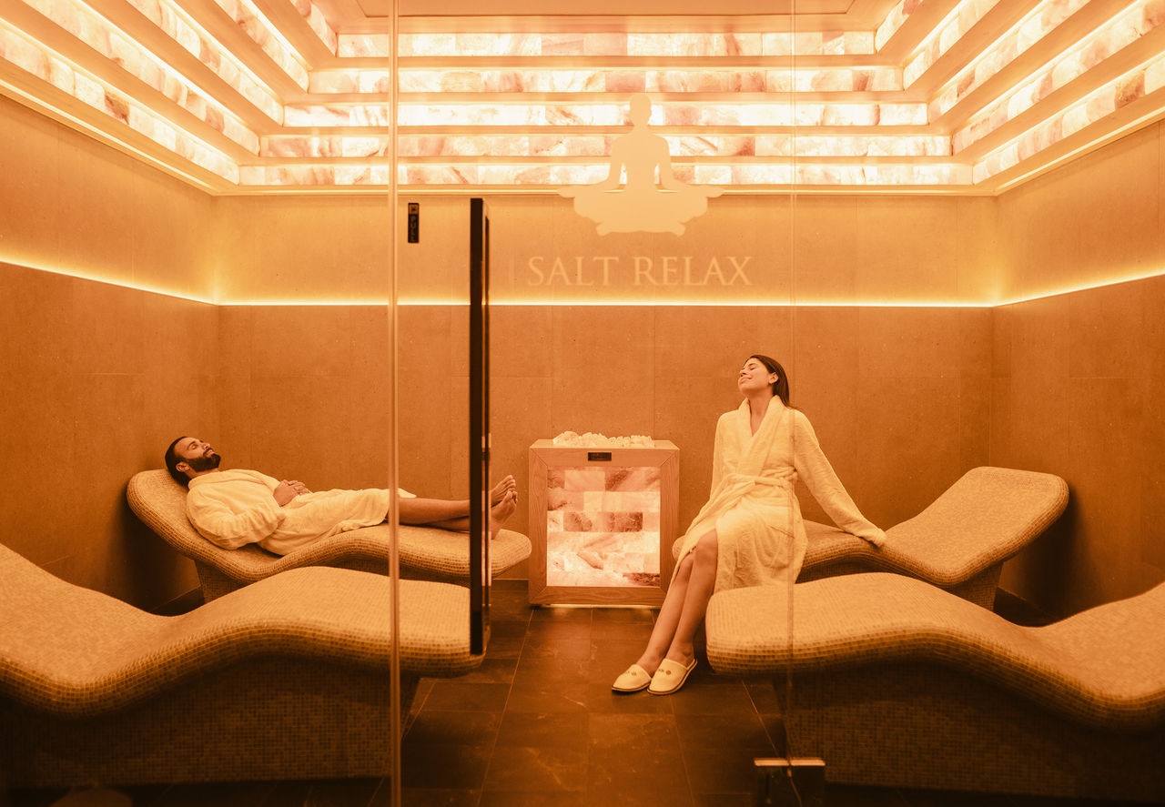 Relaxation room with heated loungers and soft lighting for a tranquil spa experience | MSC Cruises